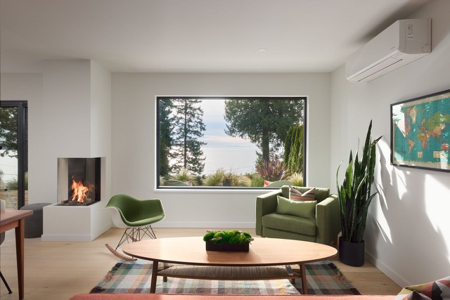 Living room with corner fireplace and ocean-view window