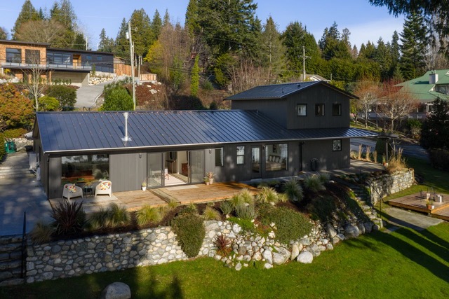 Aerial view of the renovated home, cedar deck and terraced gardens