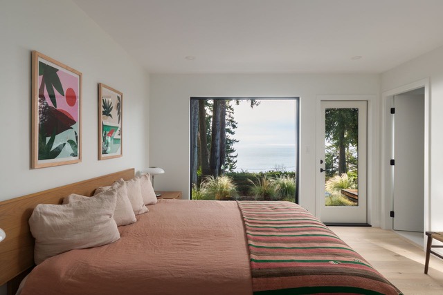 Primary bedroom with floor-to-ceiling garden view