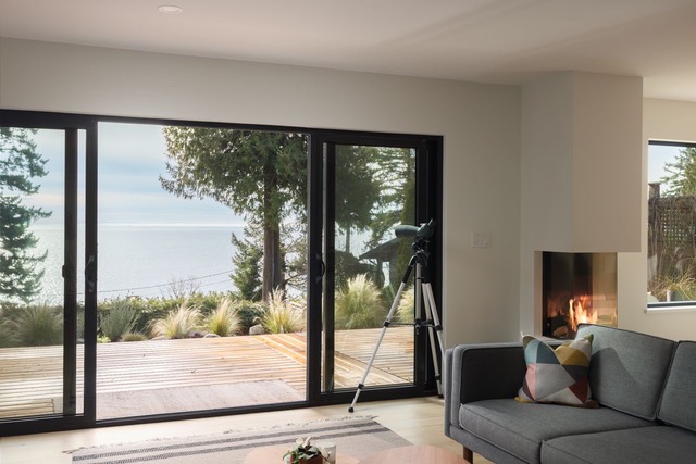 Living room with sliding glass doors to the deck and ocean view